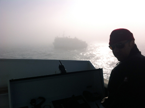 Captain Bernd Buchner of the R/V Falkor outside the bridge with the Western Flyer in the background.