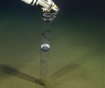 Taking a long push core of the sediments for its record of climate change over the past millennia. This core tube has been pushed in about 40 centimeters. We have successfully collected two completely full cores over 100 centimeters long!