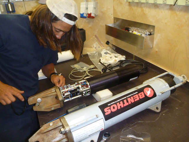 John Yeh installs an O-ring on the acoustic release for the baited camera system.
