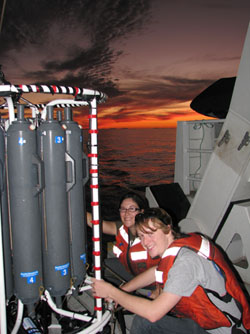 Abbey Chrystal and Joe Murray collect water samples from the bottles on the