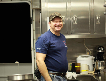The big smile on Eric Fitzgerald's face comes from the knowledge that as steward for this leg of the expedition, he holds all the real power on the ship!
