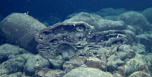 Favorite picture of the day: a lobate lava at the rim of Cage Seamount has been broken open to reveal drainage shelves (horizontal layering) formed while lava was coursing through the pillow, and the mold of an adjacent pillow that formed against it and has since fallen away (just left of center).