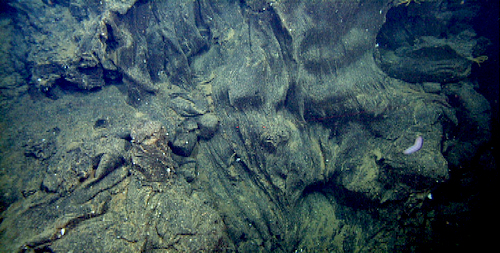cascade of lava mid-way down pond wall
