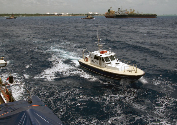 A Bahamian pilot boat attempts to come alongside Lone Ranger to offload the pilot that is required to guide large ships into local harbors. Pilots help the ship’s captain navigate through channels and are highly trained in the local water conditions and hazards of the area.