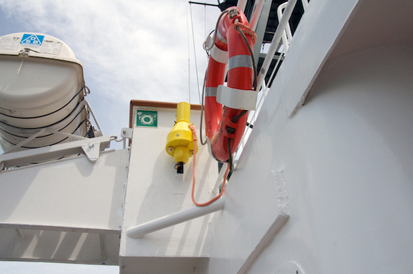 As part of the safety orientation, the captain shows the science team the location of safety gear around the ship. Here is a life ring that would be thrown into the ocean if a person were to fall overboard. These buoys provide flotation and also help visually mark the location so that the person can be rescued.