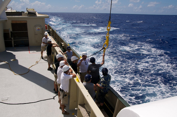 Scientists and crew prepare for recovering the deep-sea mooring tomorrow. The crane will be used to lift it out of the water and lower it onto the deck. The team walks through the process to ensure that everything goes smoothly. It is a delicate operation involving heavy equipment, a rolling ship, and sensitive scientific instruments.