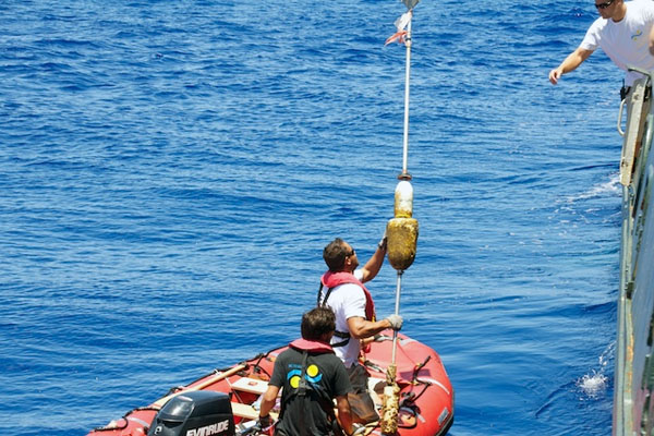 Lone Ranger crew retrieve a derelict buoy found drifting past the ship.