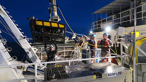 Although the mini ROV is much smaller than the Doc Ricketts, launching it still involves a coordinated effort with someone at the crane and the tether winch as well as the captain on the bridge working in unison, to ensure a safe deployment.