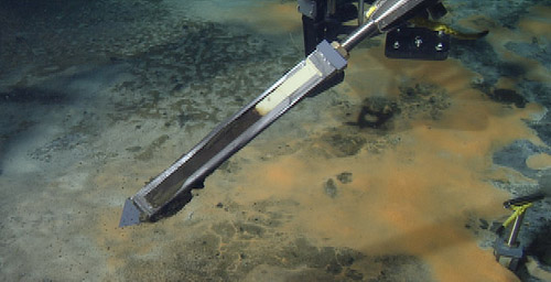 The ROV manipulator holds the peeper so we can get a frame grab of the silver film. The blackened part is where the sulfide in the sediment pore water has reacted with the silver emulsion.