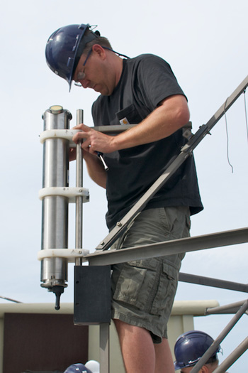 Michael Risi mounts an acoustic Doppler current meter to the frame of the Sargasso deep-sea observatory. The instrument will record current speed and direction data during the six-month deployment. Photo: Debbie Nail Meyer