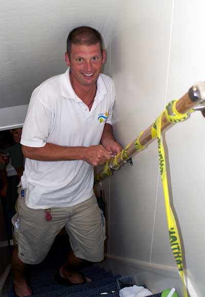 Bosun Lars Toensfeldt fixes the handrail on the main set of interior stairs. The handrail on stairs becomes your safety connection as you literally pull yourself up while the floor drops and rises underneath you during rough weather.