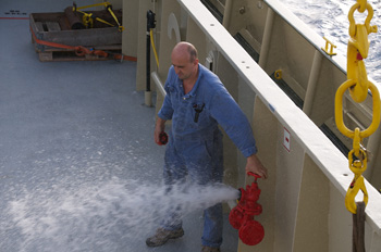 Chief Engineer Miro Mirchev releases water from the emergency response system after a fire drill. Photo: Debbie Nail Meyer