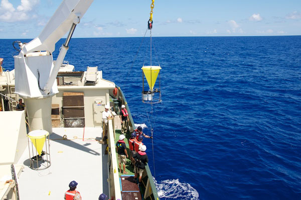 The second sediment trap is lifted out of the water. This trap is positioned 50 meters above the camera tripod frame that rests on the seafloor.