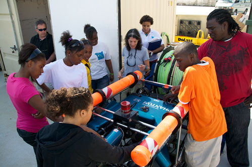 Alana Sherman shows the ROV Phantom to a group of students.