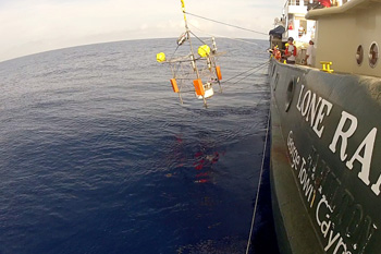 Nearly one hour later, the last component of the observatory enters the water. Photo: Debbie Nail Meyer