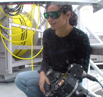 Kakani Katija calibrates the vortex generator which creates a consistent flow to compare her in situ methods with her laboratory results. She wears dark safety glasses to protect her eyes when working with lasers.