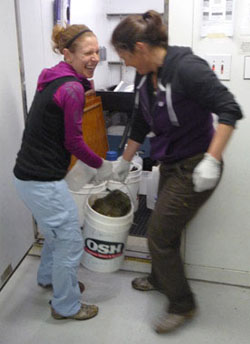 Ph.D. Student Alexis Pasulka (left) and Professor Victoria Orphan (right) carry the large rock into the cold room. I asked, “Didn’t you notice how big it was in the video?” to which she replied “Go big or go home”. I think that sums it up nicely.