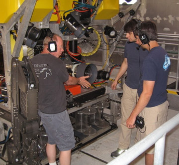 ROV pilots Knute Brekke, Bryan Schaefer, and Ben Erwin do a last minute check of the systems on the ROV.