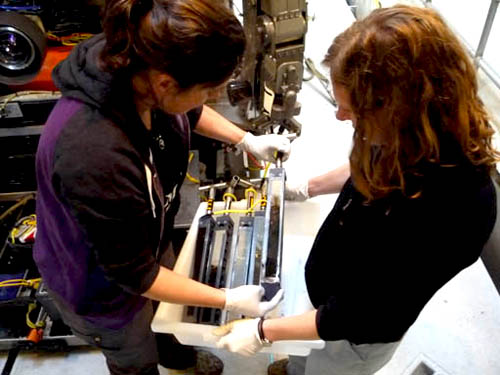 Victoria and Ally Pasulka retrieve the peepers from the ROV bio box. The ones that are darkened show that the silver emulsion paper reacted with sulfide. 