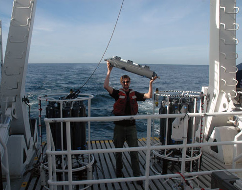 Chris removes a Niskin bottle from the rosette for “restringing.” The samples collected in each bottle are “discrete,” that is, they each represent a specific depth. If a bottle doesn’t seal completely and there’s a chance the water in the bottle isn’t exclusively from that depth, the sample must be dumped.