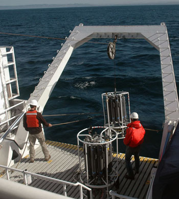 Erich Rienecker and Chris Wahl lower the CTD rosette into Monterey Bay for our first cast of the cruise.
