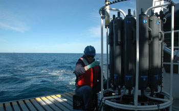 Marguerite Blum on the well deck of the Western Flyer drawing samples from the Niskin bottles brought back from the depths during this morning’s CTD cast.