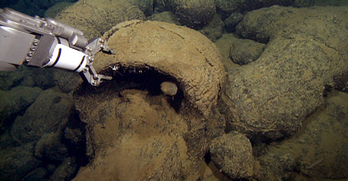 The ROV manipulator collecting a sample of a drained lava pillow rind.