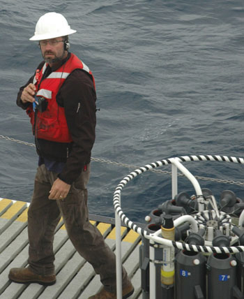 CTD technician Erich Reinecker on the well deck of the Western Flyer. With the headset he’s wearing, Erich communicates with the captain, the winch operator, and Curt Collins, who is monitoring the real-time readings the CTD is sending back during the cast.