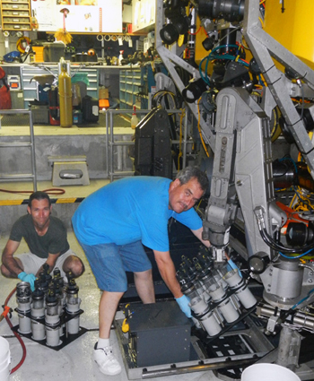 Ronald Spelz and Rigoberto Guardado reload the push core racks on the ROV in preparation for the next dive.