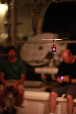 In their off time, the ROV pilots hone their flying skills with remote controlled helicopters in the moon pool.