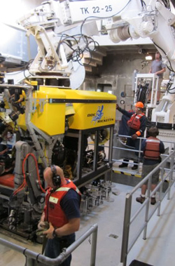 ROV pilots, Knute Brekke and Randy Prickett, work with the ship’s crew Andrew McKee and Olin Jordan to relaunch the ROV. All the pilots and crew are needed to assist during the daily launches and recoveries.
