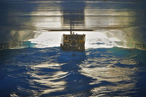 Our Second Mate, Andrew McKee, took this photo of the remotely operated vehcile (ROV) Doc Ricketts being recovered this morning. He lowered a camera from the bow aimed back between the ship's hulls, and snapped the photo as the vehicle was being lifted through the moon pool at the center of the ship.