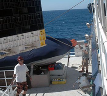 Time to start packing up. First mate Andrew McKee and Able bodied seaman Craig Heihn bring our storage bins down from the roof of the Western Flyer.