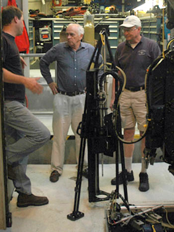 At the end of the day, Chief Scientist Peter Brewer, center, meets with his team, Peter Walz, left, and Ed Peltzer, to discuss how to improve the performance of their newest tool, the tripod, designed to precisely guide the laser probe into the seafloor.