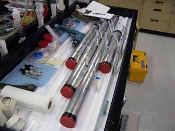 Syringes and tubing are inserted into today's vibracores in order to extract the pore water from within the sediment samples.