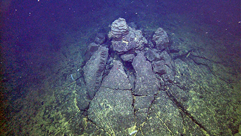 The roof of a ponded and inflated flow collapsed around the lava pillar that could no longer support it when the molten interior of the flow drained.