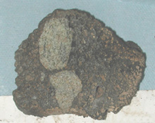 Lava (brown) containing olivine-rich xenoliths (greenish) collected offshore of Kauai. Photo © MBARI 2001