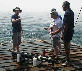 Researchers, including Kanna Rajan (right), prepare to launch a autonomous underwater vehicle (AUV) from the ramp of a landing craft supplied by the Portuguese Navy. Image: Marina Oliveira.