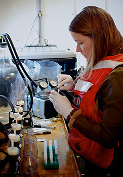 Postdoctoral Fellow Holly Bowers processes samples of seawater that will be used for later laboratory analysis on shore. Image: Eric Martin