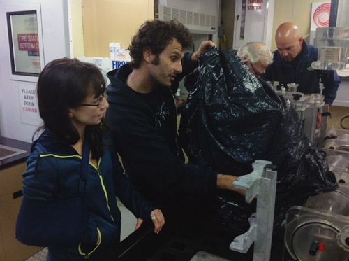 Chris Payne and Alicia Bitondo quickly put the vampire squid in the cold room, keeping it covered to reduce exposure to light.