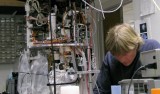 The Environmental Sample Processor (left) has to have all the chemicals, containers, and computers of a full-sized laboratory. Inventing ways to pack them all into a waist-high cylinder keeps Chris Scholin (right) and his colleagues busy. Image: Kim Fulton-Bennett, MBARI.