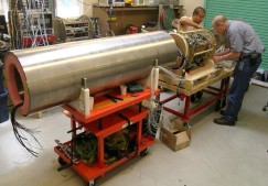 Technicians Dick Littlefield and Jose Rosal work on the electronics that fit inside one of the MARS node's titanium pressure cylinders. After sealing, the canister will hang under the MARS node's yellow foam block (see above photo). Photo: Kim Fulton-Bennett (c) 2005 MBARI.