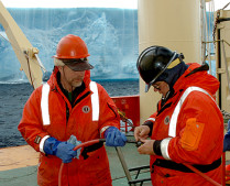 Researchers on Ken Smith's iceberg research cruise examine the tether for the remotely operated vehicle that was used to study animals living underneath Antarctic icebergs.