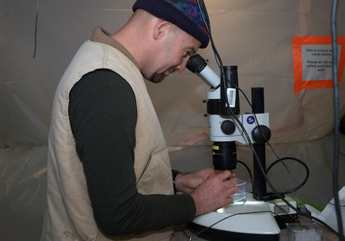Rob Sherlock uses a microscope to identify an unknown jelly from a MOCNESS trawl. Photo by Debbie Nail Meyer.