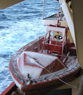 A coating of snow collects on a workboat located below the starboard lifeboat. Photo by Gordy Stephenson.