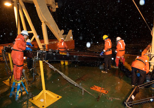 The MOCNESS team recovers the nets after an overnight tow near iceberg C-18A. Photo by Debbie Nail Meyer.