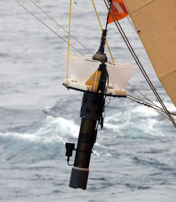 A Lagrangian sediment trap (LST) is lifted onto the deck with the starboard A-frame. The LST drifted at 600 meters depth for three days, during which its four funnels captured particles sinking from surface waters. Photo by Debbie Nail Meyer.