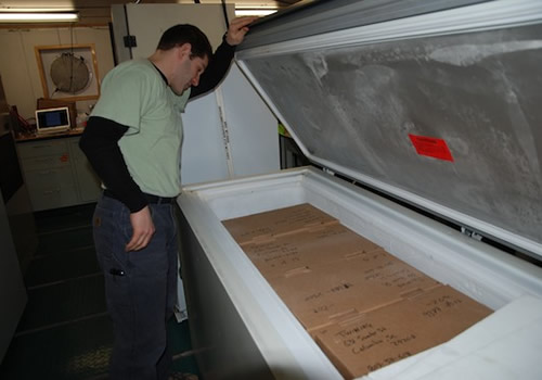 Ben Twining checks the boxes of frozen samples that will be shipped in special temperature-controlled boxes back to the University of South Carolina. Photo by Debbie Nail Meyer.