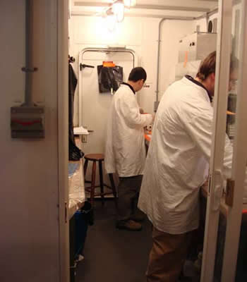 Hai Lin and Scott Kindelberger do iron and peroxide analyses in the trace metal van. The portable laboratory provides a clean environment, reducing the chance of sample contamination from external sources. Photo by Amanda Kahn.