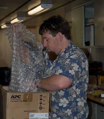 Jake Ellena packs a box for shipping back to MBARI. Photo by Debbie Nail Meyer.